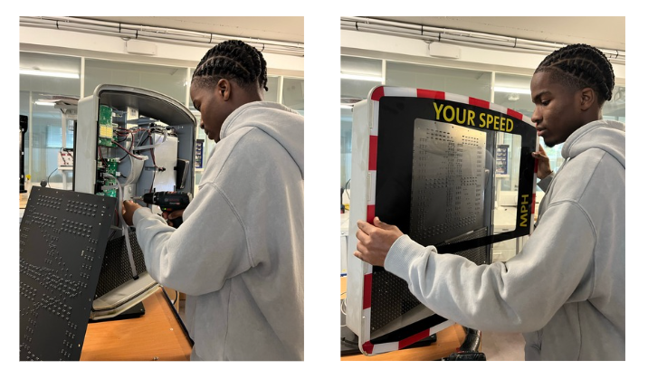 A customer service technician repairing an EVOLIS Vision radar speed sign